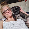 Puppy Girl joined the competition — help win amazing prizes! black_dog, casual, closeup, companion, couch, dog, glasses, home, indoors, lying_down, person, pet, portrait, puppy, selfie, sitting, small_dog, smiling, white_shirt, woman