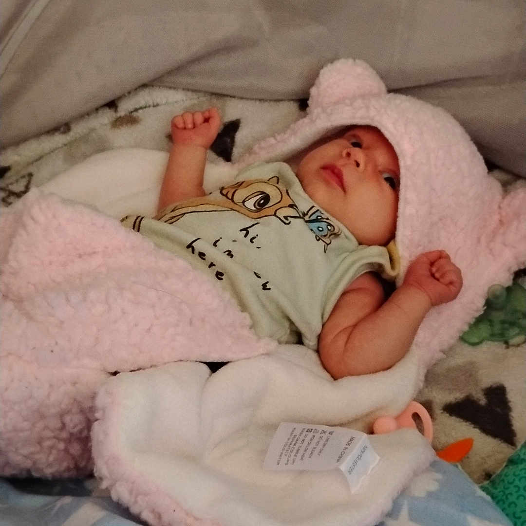 Hailey joined the competition — help win amazing prizes! baby, bed, bedroom, blanket, bonnet, clothing, crib, face, furniture, hat, head, indoors, infantbed, newborn, person, photography, portrait, quilt, room, sleeping