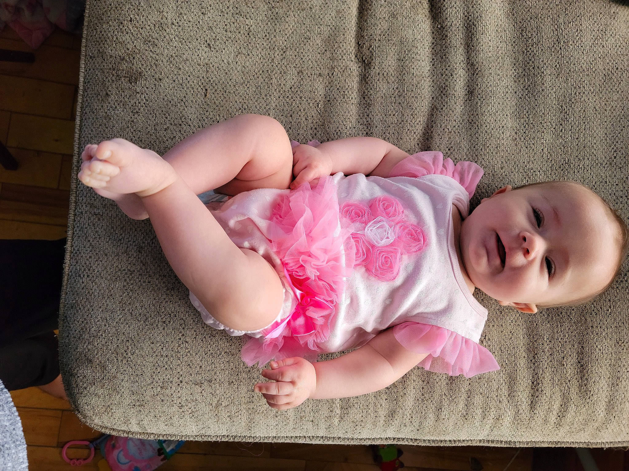 Lacey is registered to the contest to win money with this photo: baby, baby_toddler_clothing, cheek, child, comfort, eye, finger, head, headgear, human_body, human_leg, lip, pattern, person, pink, sitting, skin, sleeve, textile, thigh