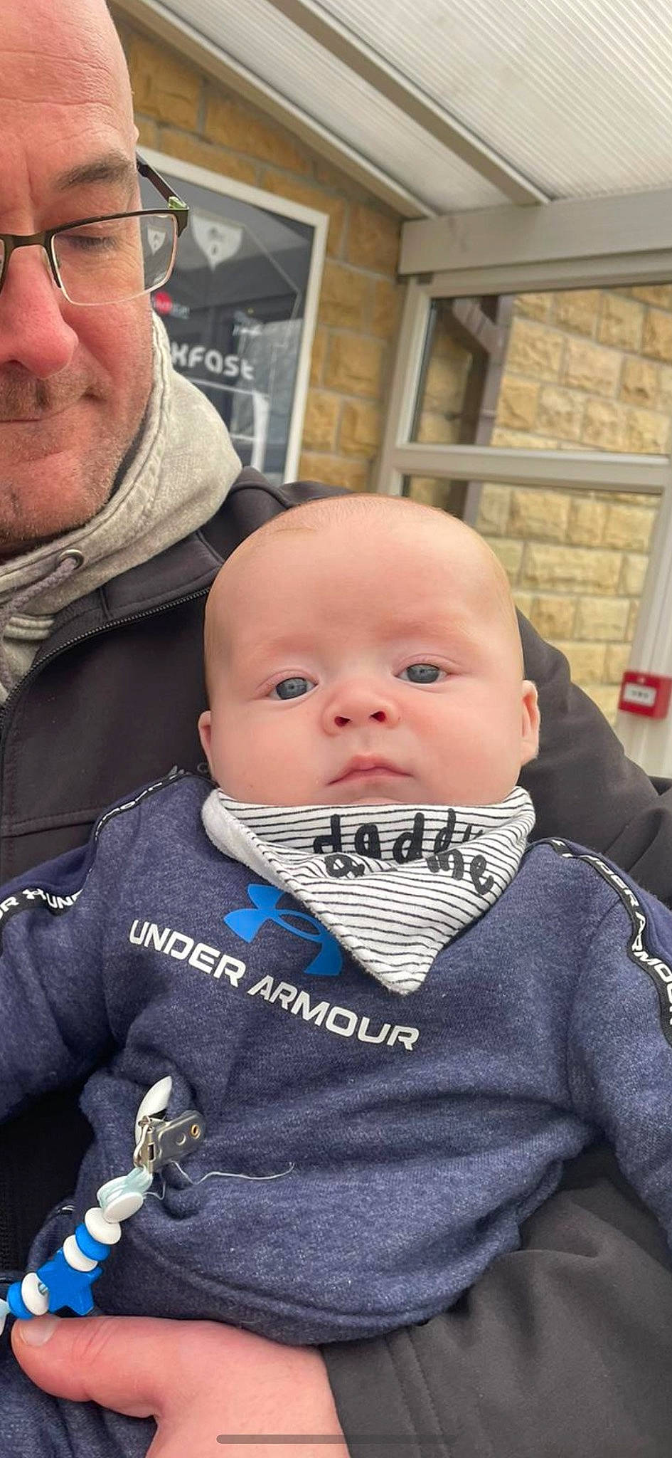 Otis is registered to the contest to win money with this photo: baby, baby_products, baby_toddler_clothing, cheek, child, chin, comfort, cool, face, fun, happy, iris, outerwear, person, personal_protective_equipment, sitting, skin, sleeve, toddler, vacation