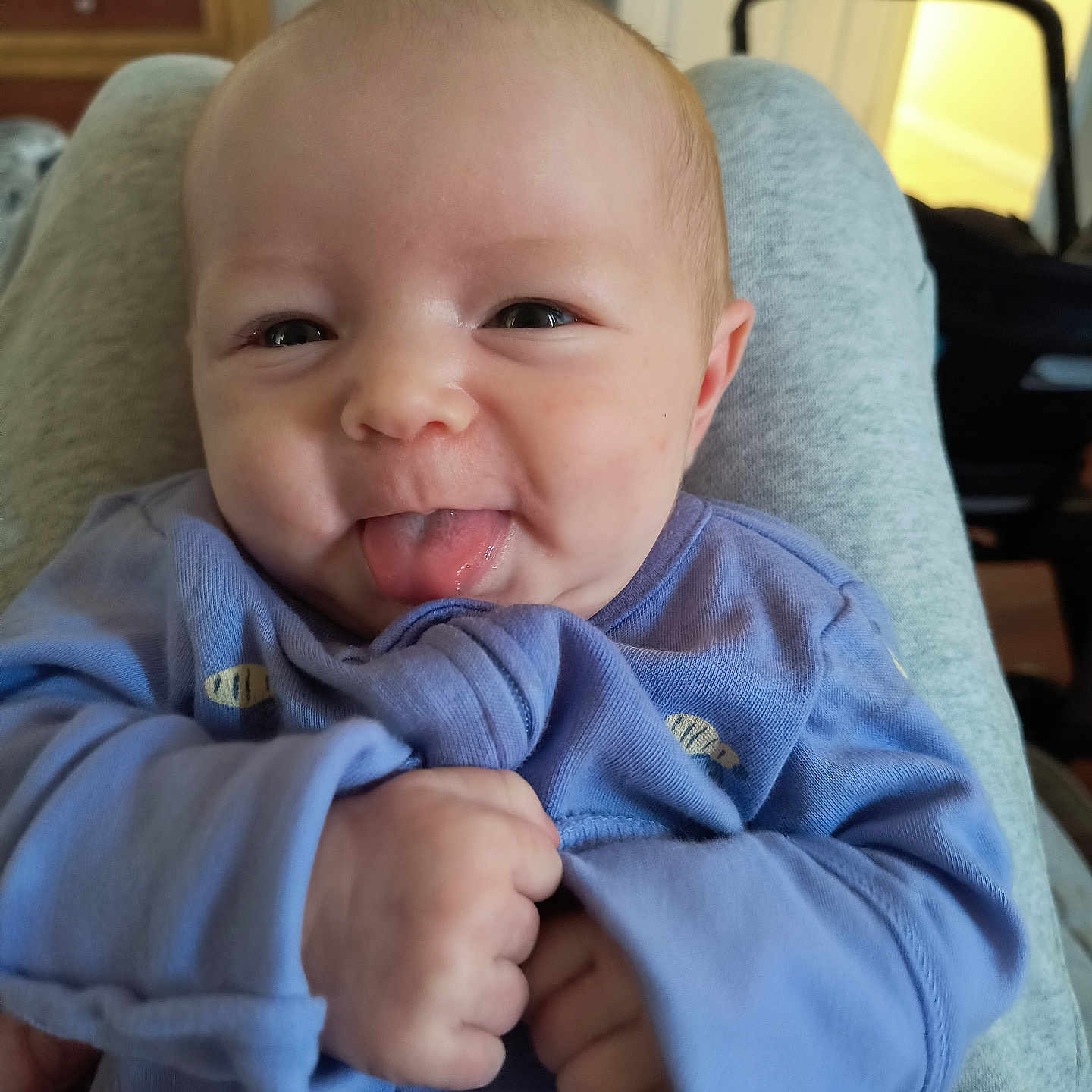 Lettie joined the competition — help win amazing prizes! baby, bodypart, clothing, couch, cushion, face, finger, furniture, hand, head, homedecor, knitwear, mouth, newborn, person, photography, portrait, sweater, sweatshirt, tongue