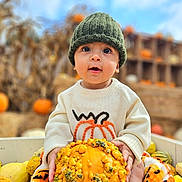 Riley is registered to the contest to win money with this photo: baby, child, pumpkin, autumn, fall, hat, knit_hat, sweater, gourd, hay, orange, yellow, outdoor, seasonal, cute, portrait, smiling, nature, harvest, festival