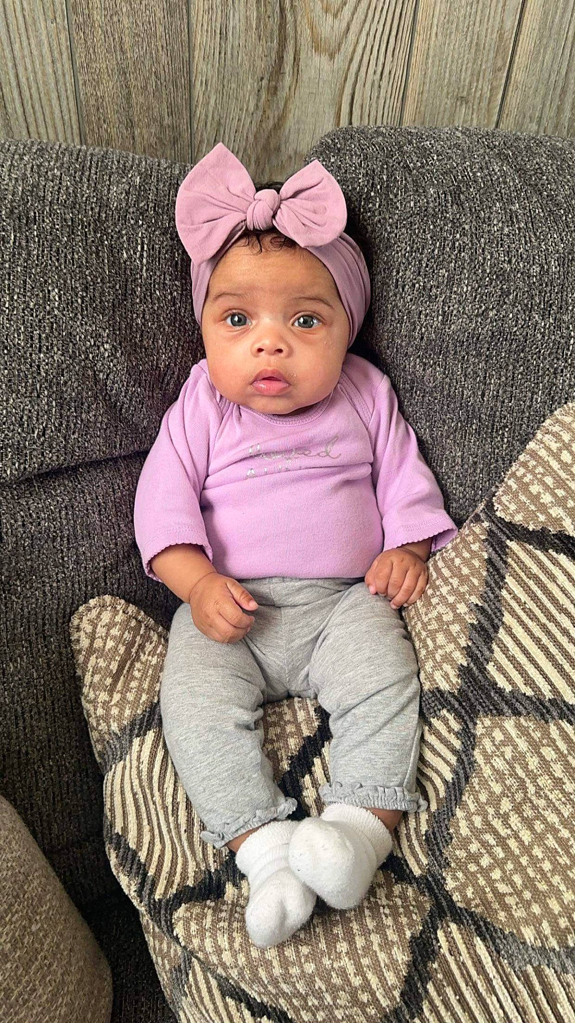Zyra is registered to the contest to win money with this photo: baby, baby_products, baby_toddler_clothing, cap, cheek, comfort, eye, face, fashion_accessory, head, headwear, lip, magenta, outerwear, person, pink, purple, skin, sleeve, textile
