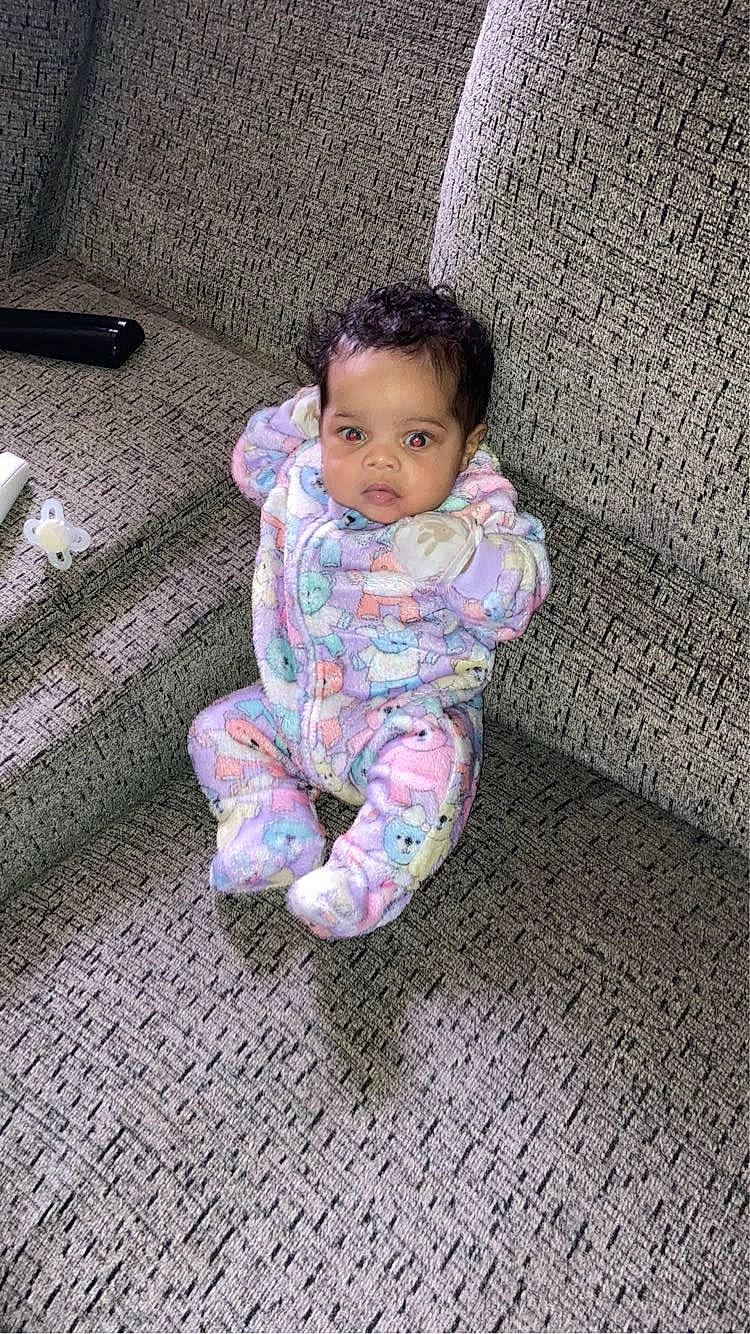 Zyra is registered to the contest to win money with this photo: baby, baby_toddler_clothing, cheek, child, comfort, crawling, floor, flooring, foot, grass, human_body, linens, magenta, pattern, person, purple, sitting, skin, sleeve, toddler