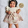 Presley is registered to the contest to win money with this photo: baby, infant, girl, crocheted_dress, headband, tongue_out, milestone_sign, five_months, blanket, cute, playful, lying_down, skin, hand, foot, smiling, portrait, child, indoor, soft_texture
