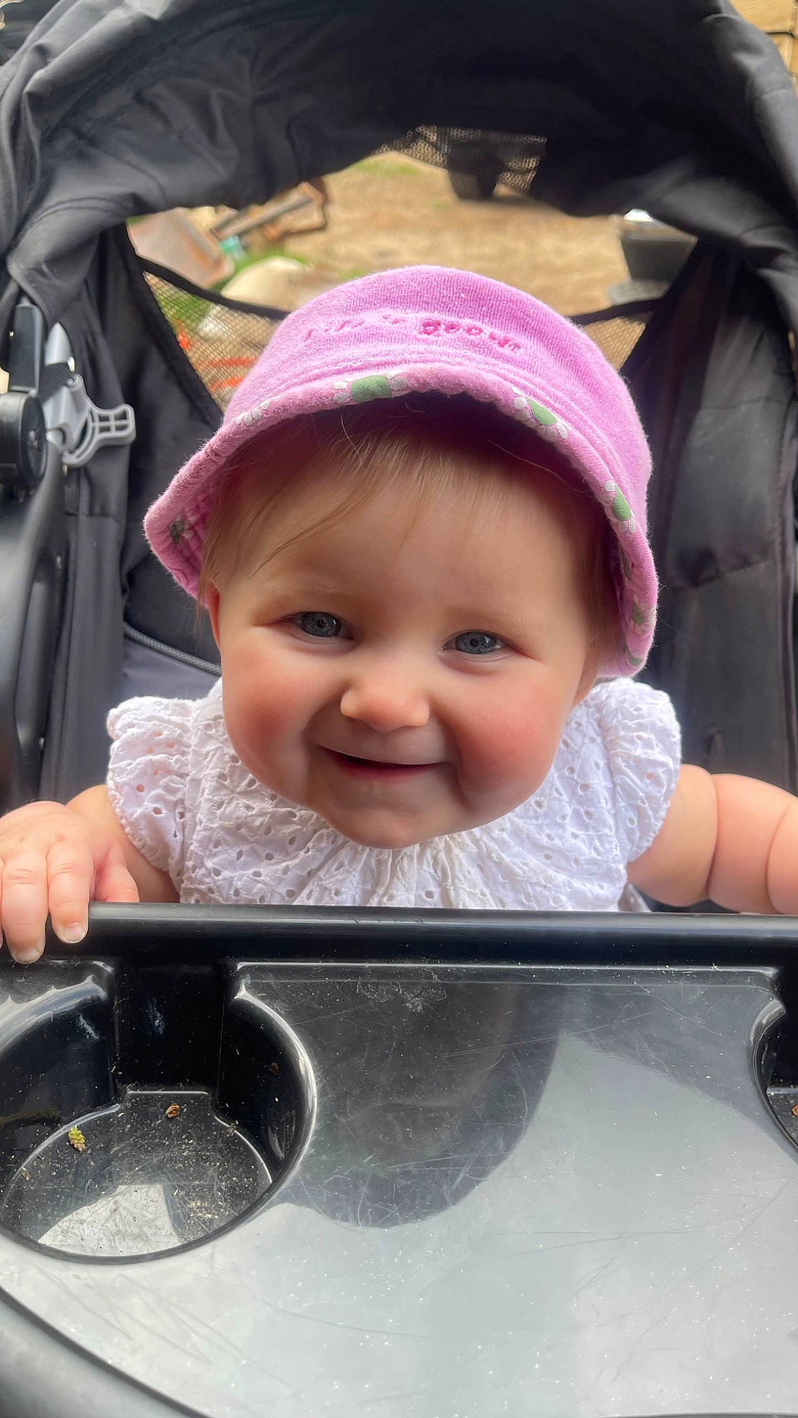 Hazel is registered to the contest to win money with this photo: baby, baby_carriage, baby_products, baby_toddler_clothing, cap, cheek, child, eye, eyelash, facial_expression, hairstyle, happy, joy, lip, mouth, nose, person, pink, product, skin