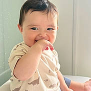 Victor joined the competition — help win amazing prizes! baby, child, dinosaur_clothing, cute, smiling, hand_in_mouth, sitting, indoors, shorts, tshirt, window, light, skin, portrait, happy, young_child, infant, casual, comfort, playful