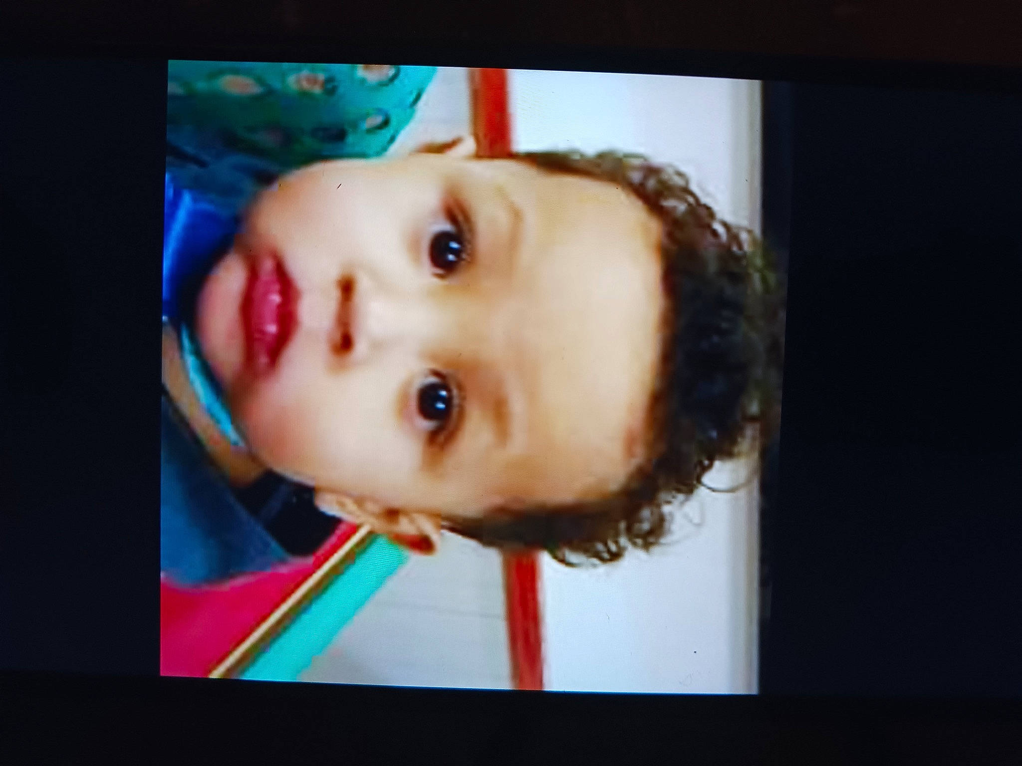 Junior is registered to the contest to win money with this photo: art, baby, cheek, child, chin, display_device, electric_blue, eyebrow, eyelash, facial_expression, flash_photography, fun, jaw, lip, mouth, nose, person, picture_frame, room, toddler