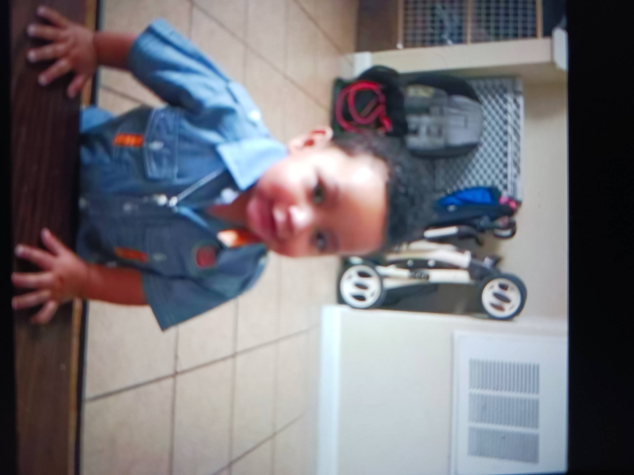 Junior is registered to the contest to win money with this photo: automotive_design, automotive_tire, baby, child, electric_blue, fun, helmet, joy, machine, person, personal_protective_equipment, room, sitting, smile, suit, tire, toddler, toy, wheel