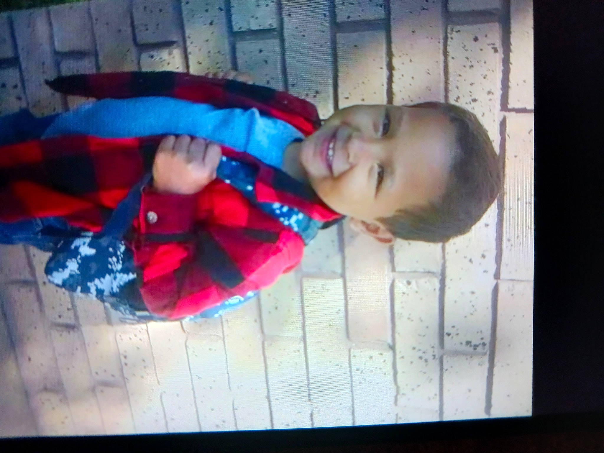 Terrell is registered to the contest to win money with this photo: baby, baby_toddler_clothing, carmine, child, display_device, electric_blue, fun, happy, joy, magenta, pattern, person, rectangle, room, sleeve, smile, square, toddler, window