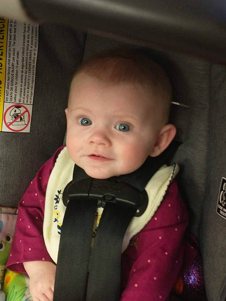 Ireland is registered to the contest to win money with this photo: baby, baby_products, baby_toddler_clothing, car_seat, cheek, child, clothing, collar, eyebrow, formal_wear, fun, iris, jacket, nose, outerwear, person, seat_belt, skin, sleeve, smile