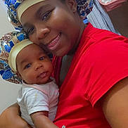Novah is registered to the contest to win money with this photo: baby, child, siblings, portrait, selfie, smiling, cuddling, bonnet, matching_outfits, red_shirt, infant, newborn, family, indoor, nursery, bedroom, blanket, gloves, purple_hearts, text_overlay