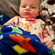 Athea joined the competition — help win amazing prizes! baby, infant, blanket, colorful, fish_pattern, couch, soft, cozy, expression, face, child, indoors, clothing, pajamas, hand, comfort, resting, portrait, cute, young