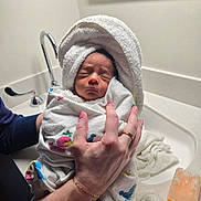 Jacob is registered to the contest to win money with this photo: adult, baby, bathroom, blanket, caregiving, face, family, hands, holding, indoors, infant, newborn, peaceful, photography, portrait, sink, sleeping, swaddled, towel, wrapped