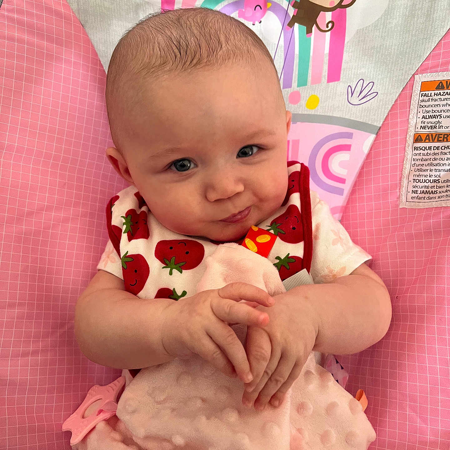 Lucy Lu is registered to the contest to win money with this photo: baby, bib, blanket, cartoon, child, clothing, comfort, cute, face, hand, indoor, infant, monkey, pattern, pink, playful, rainbow, seat, smile, toy