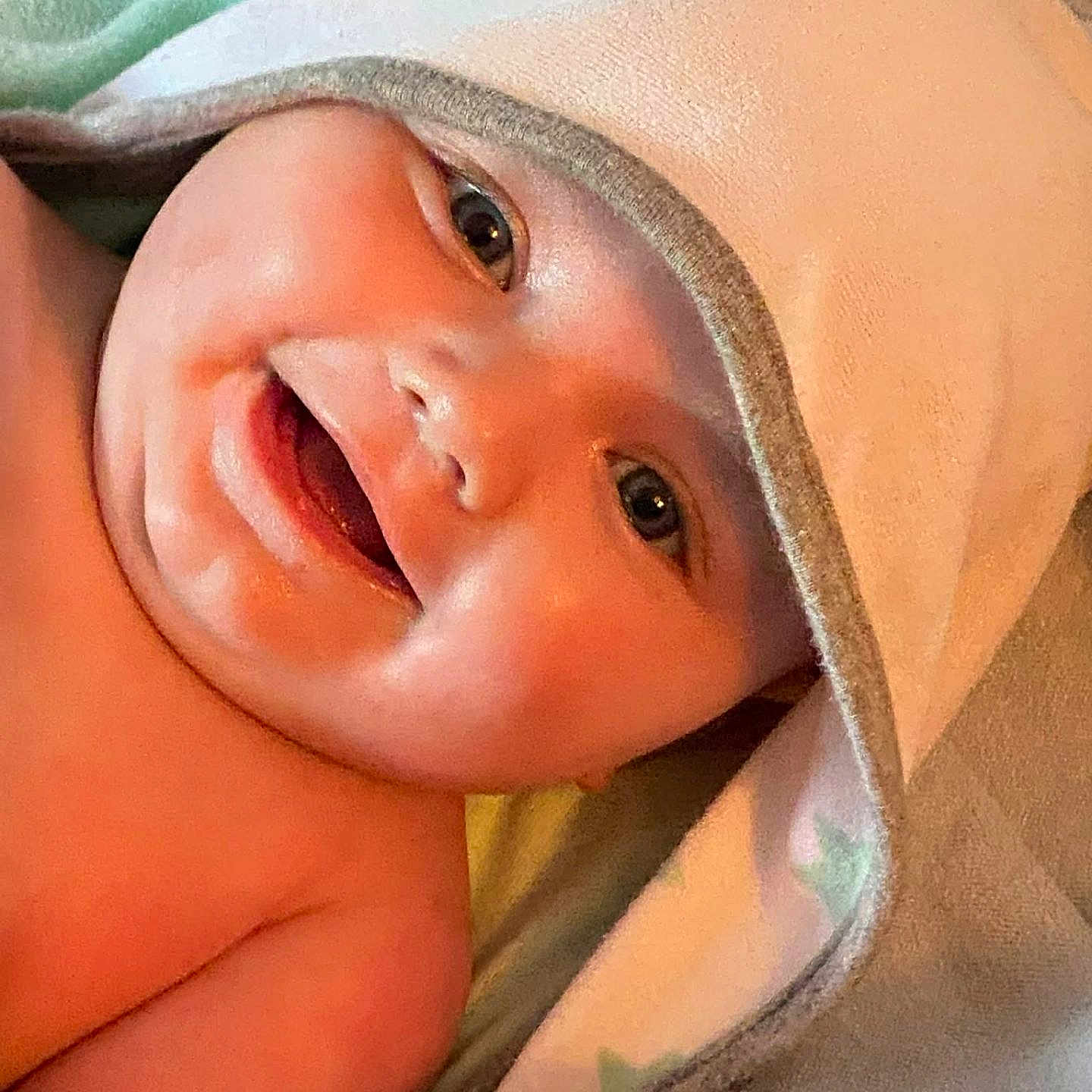 Virgil is registered to the contest to win money with this photo: baby, smiling, face, hooded_towel, pacifier, skin, child, infant, closeup, happy, cute, portrait, newborn, warm, soft, blanket, relaxation, comfort, indoors, person