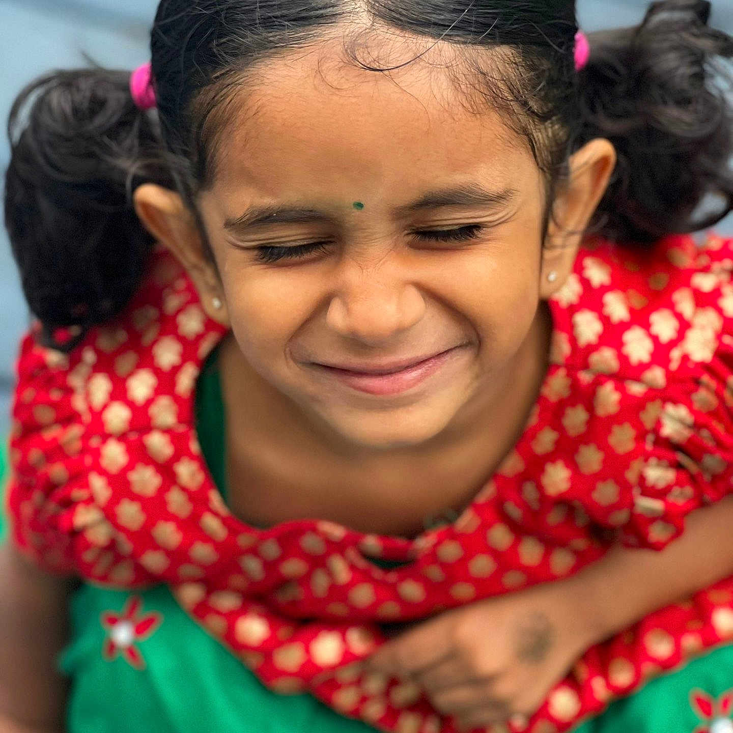 Sneha Chowdary joined the competition — help win amazing prizes! bindi, child, close-up, cute, earrings, face, fashion, flower_pattern, girl, green_skirt, happy, indoor, person, pigtails, playful, portrait, red_dress, smiling, traditional_clothing, young