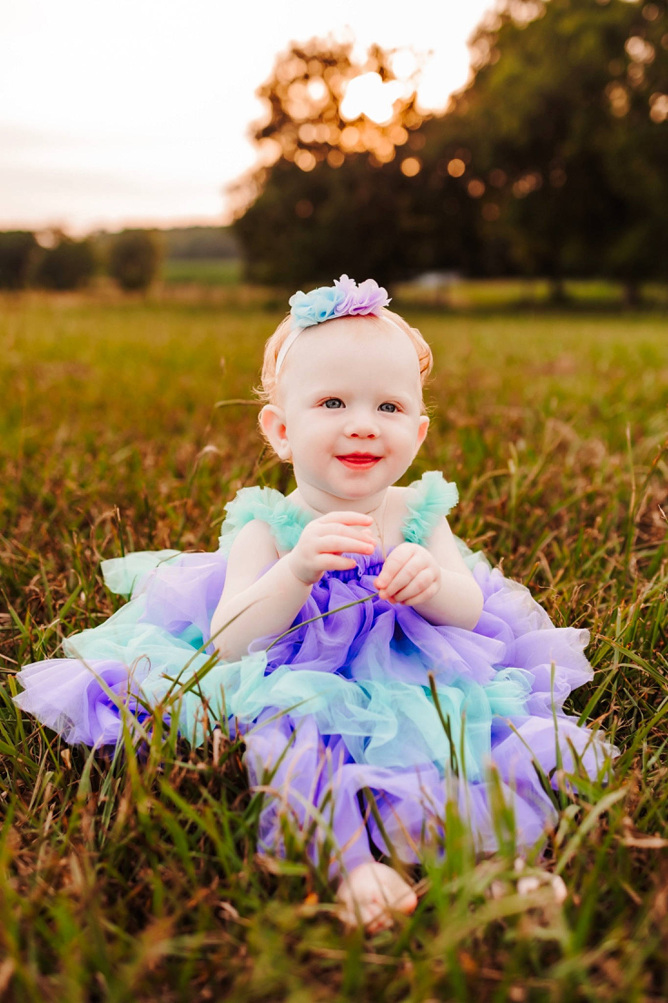 Kaydence joined the competition — help win amazing prizes! baby, baby_toddler_clothing, dress, flash_photography, grass, grassland, happy, headpiece, joy, light, meadow, people_in_nature, person, pink, plant, purple, sky, smile, sunlight, toddler