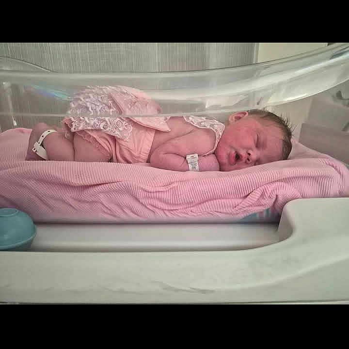 Keeley joined the competition — help win amazing prizes! newborn, baby, hospital, bassinet, pink_blanket, sleeping, infant, clothing, hospital_id_band, cute, peaceful, medical, indoors, portrait, resting, child, human, baby_girl, soft, tender