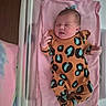 Keeley is registered to the contest to win money with this photo: newborn, baby, infant, blanket, pink, onesie, leopard_print, hospital, crib, sleeping, person, child, cute, resting, headwear, clothing, portrait, indoors, small, baby_bed