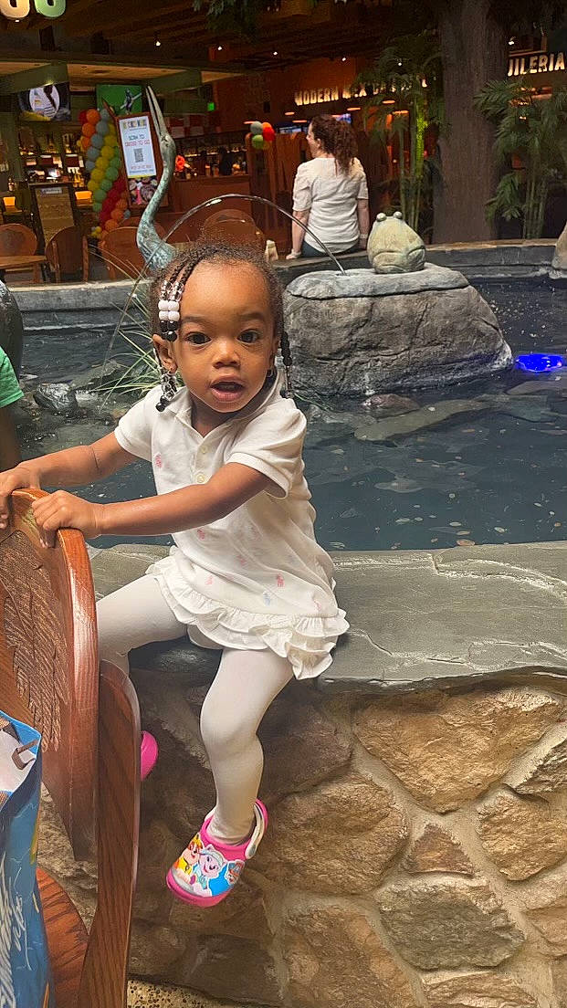 Jahlaya is registered to the contest to win money with this photo: child, city, event, flip_flops, fun, grass, happy, human_settlement, leisure, person, public_space, road, sandal, sidewalk, sitting, skin, street, surprise, t_shirt, toddler