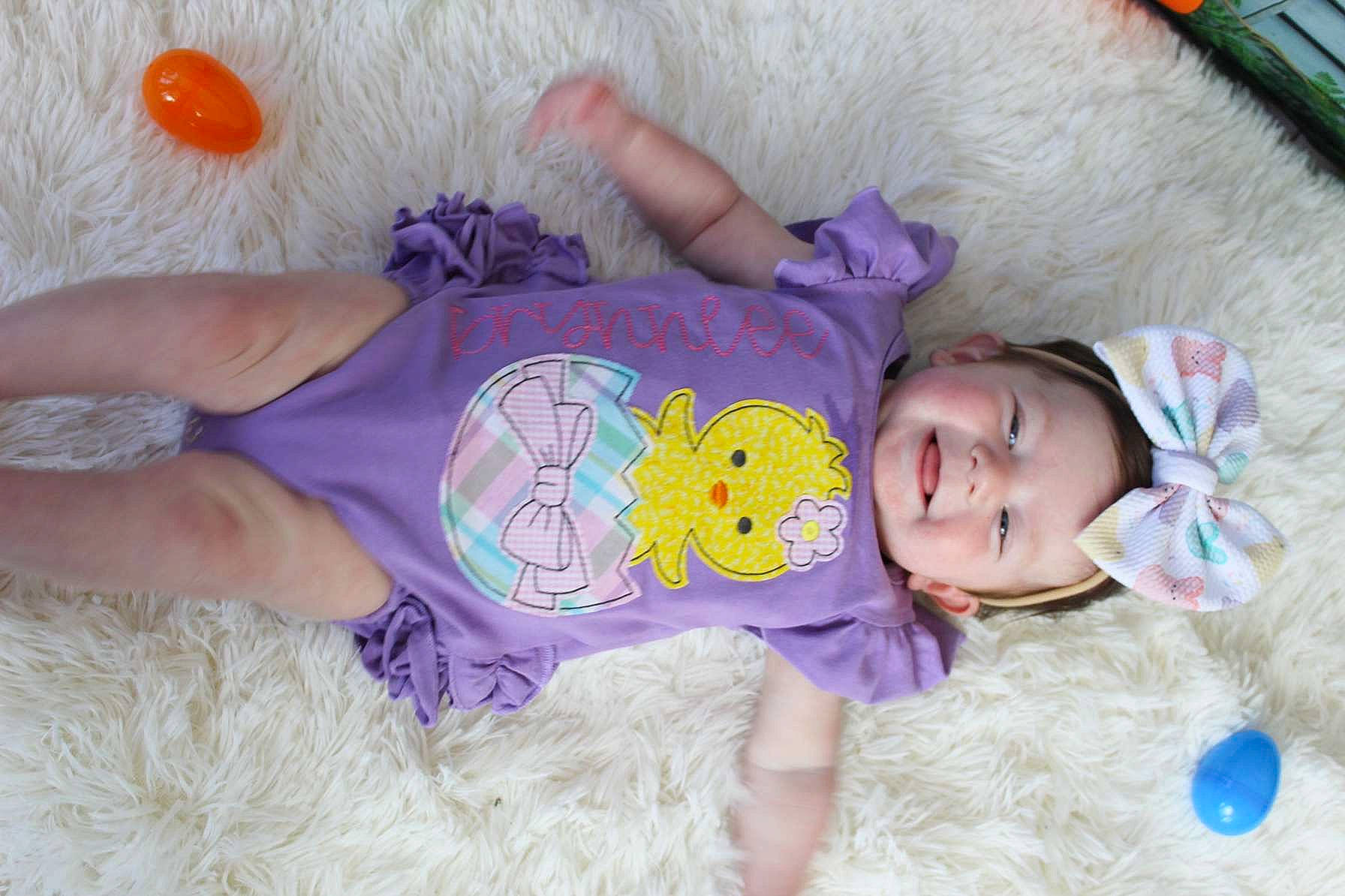 Brynnlee is registered to the contest to win money with this photo: baby, baby_toddler_clothing, cheek, child, clothing, comfort, fun, head, headgear, joy, mammal, organ, people, person, pink, purple, skin, sleeve, textile, toddler