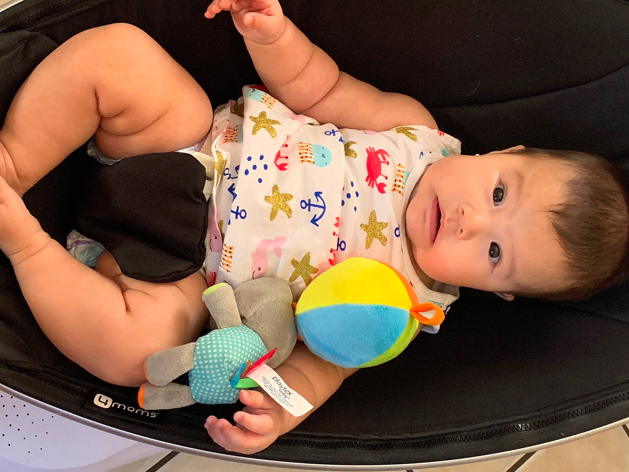 Melani is registered to the contest to win money with this photo: baby, baby_playing_with_toys, baby_products, baby_toddler_clothing, child, comfort, finger, fun, hand, happy, human_leg, nail, person, play, product, sitting, smile, textile, thigh, toddler