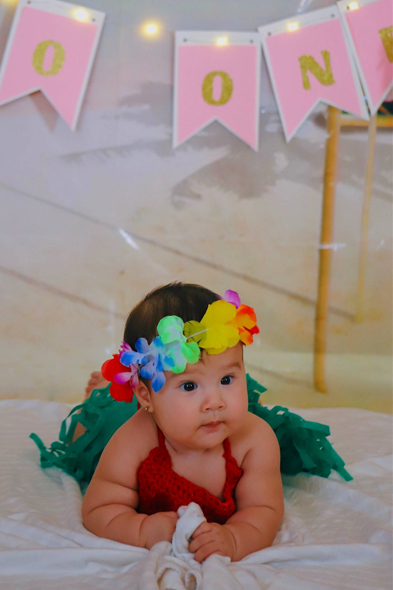 Melani is registered to the contest to win money with this photo: baby, baby_toddler_clothing, child, costume, costume_hat, event, fashion_accessory, flooring, fun, hair_accessory, happy, headband, headpiece, headwear, leisure, party_supply, person, pink, room, sitting
