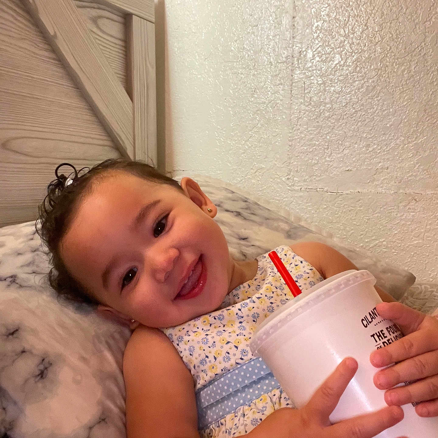 Alyssa is registered to the contest to win money with this photo: baby, beverage, bodypart, cream, cup, dessert, disposablecup, face, finger, food, furniture, hand, happy, head, icecream, indoors, person, photography, portrait, smile