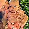 Tahlia is registered to the contest to win money with this photo: baby, child, woman, kiss, affection, nature, greenery, outdoor, portrait, closeup, holding, clothing, bow, skirt, expression, face, hand, love, parent, family