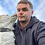 man, dog, hoodie, pet, outdoor, sky, canine, portrait, casual, affection, closeup, fur, collar, beard, expression, human, friendship, animal, head, nature