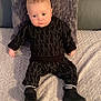baby, infant, child, blanket, pillow, clothing, black_shoes, socks, bed, texture, portrait, indoor, cute, fashion, infant_clothing, person, young_child, sitting, looking, soft