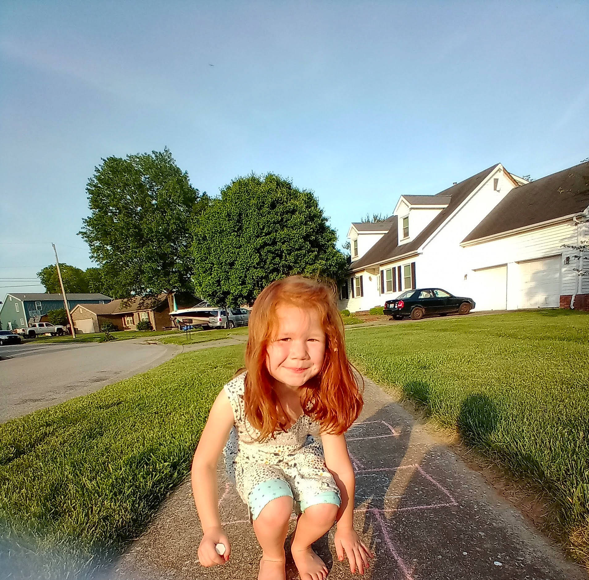 Zayna is registered to the contest to win money with this photo: asphalt, grass, grass_family, grassland, happy, house, human_leg, joy, landscape, leaf, leg, leisure, morning, people_in_nature, person, plant, road_surface, sky, sunlight, toddler