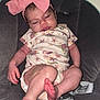 baby, infant, pink_bow, headband, onesie, floral_pattern, baby_seat, seat_belt, sleepy, cute, indoor, child, small_feet, relaxing, portrait, infant_clothing, baby_fashion, toddler, person, skin