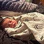 Aurorah is registered to the contest to win money with this photo: baby, newborn, sleeping, blanket, swaddled, elephant_print, mountain_print, bed, bedding, soft, cozy, indoor, infant, peaceful, resting, portrait, cute, child, sleep, warm