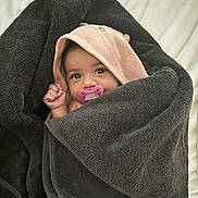 Reigny is registered to the contest to win money with this photo: baby, blanket, clothing, face, happy, head, hood, person, photography, portrait, quilt, smile, towel