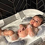 Reigny is registered to the contest to win money with this photo: baby, bathing, bathtub, face, head, hottub, person, tub