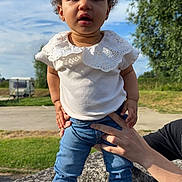 Rose participe au concours pour gagner de l'argent avec cette photo : baby, clothing, dress, face, footwear, grass, head, jeans, outdoors, pants, person, photography, plant, portrait, rock, sandal, shoe, sitting, sleeve, walking