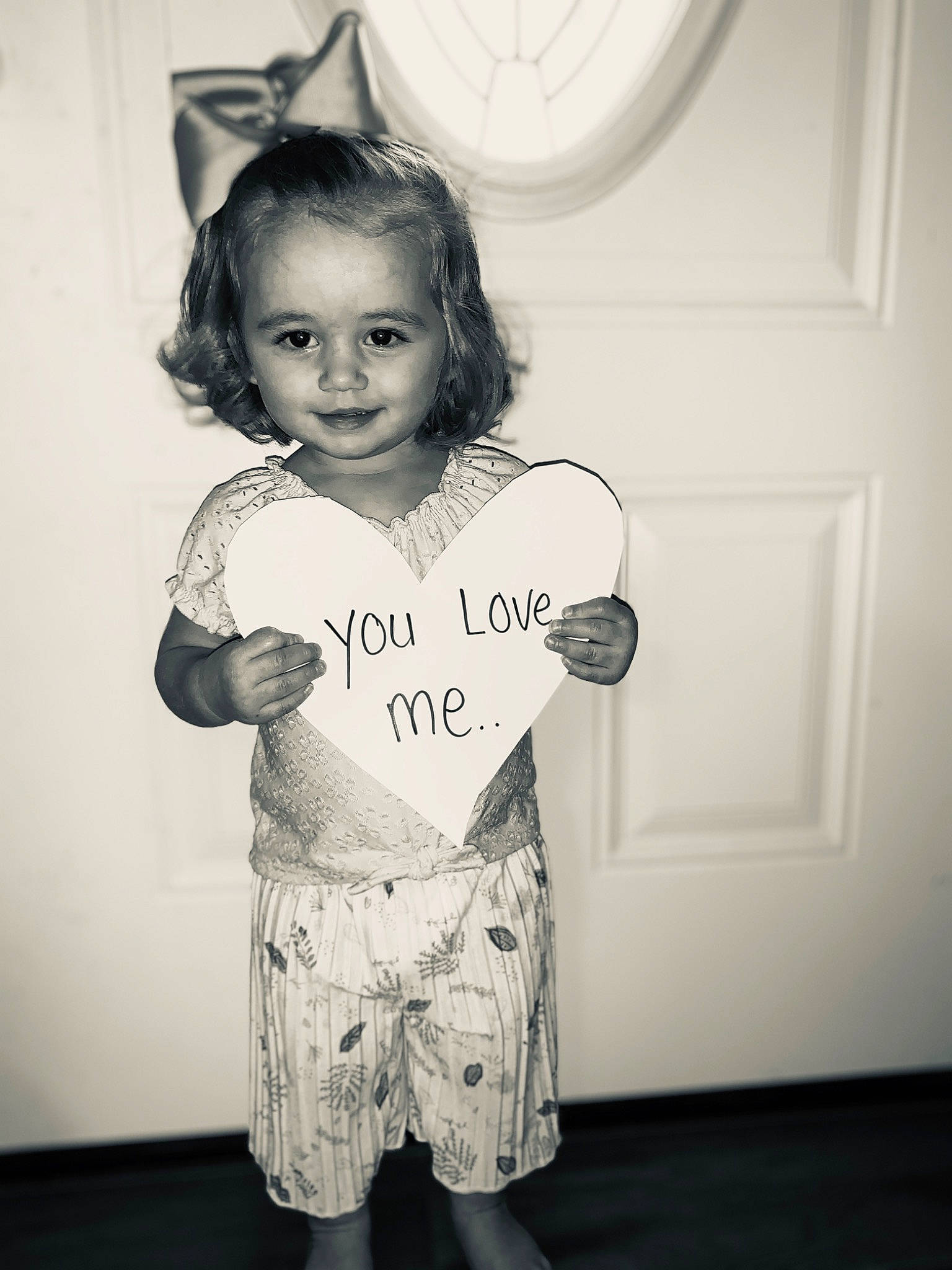 Kinleigh Ivy joined the competition — help win amazing prizes! arm, black_and_white, child, ear, eye, face, facial_expression, happy, head, monochrome, nose, paper, person, photography, room, smile, standing, style, t_shirt, toddler