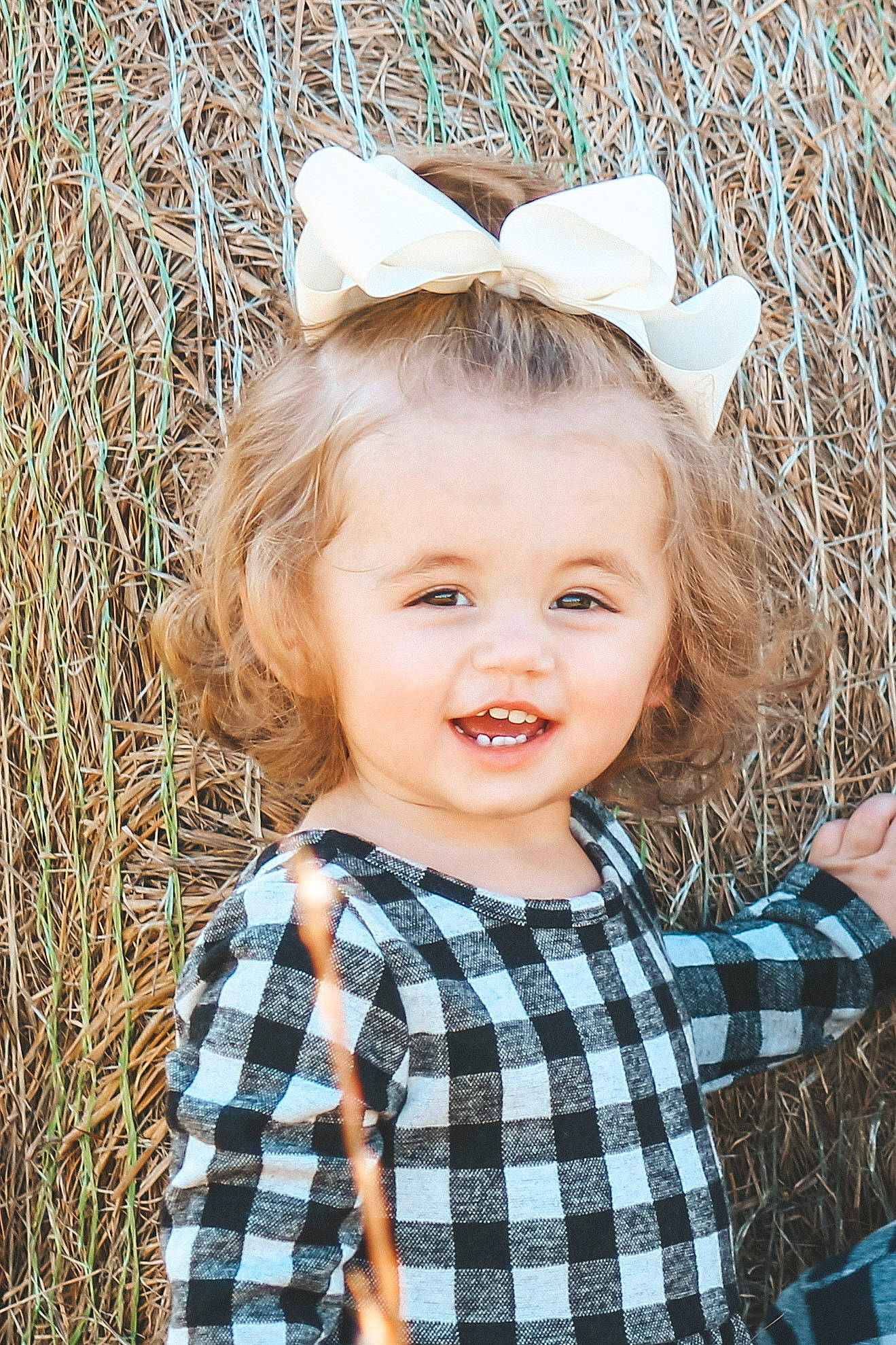 Kinleigh Ivy is registered to the contest to win money with this photo: baby_toddler_clothing, blond, child, child_model, design, ear, face, fashion_accessory, hair, hair_accessory, head, headgear, joy, pattern, person, photograph, photography, plaid, portrait_photography, smile