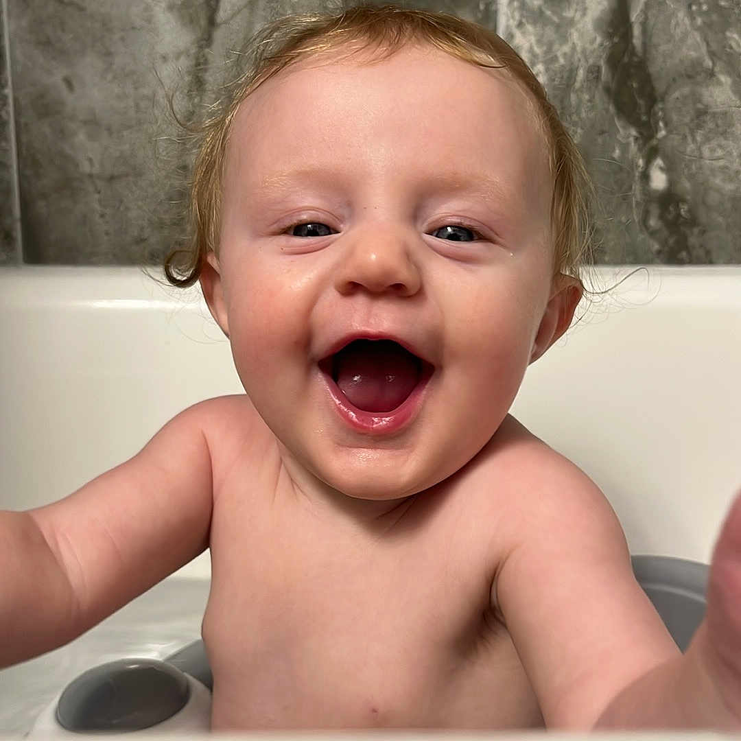 Arya is registered to the contest to win money with this photo: arm, baby, bathroom, bathtub, child, cute, expression, face, fun, happy, infant, joy, playful, portrait, skin, smile, splash, tile, water, young