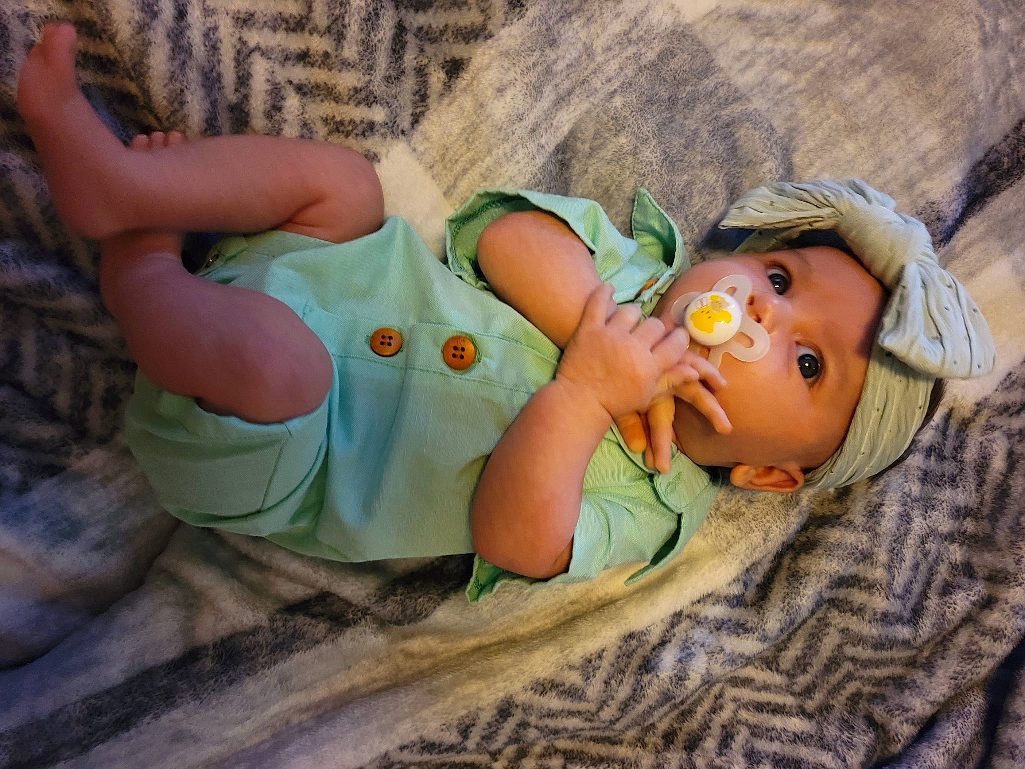 Eden joined the competition — help win amazing prizes! baby, baby_toddler_clothing, child, doll, fun, grass, hat, headgear, headwear, joint, leisure, linens, pattern, person, plastic, rock, sitting, thigh, toddler, toy