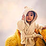 Krishnendu is registered to the contest to win money with this photo: child, toddler, portrait, smiling, face, hood, robe, teddy_bear, plush, chair, indoor, cozy, fashion, cute, sitting, standing, brown_hair, barefoot, soft_lighting, photography
