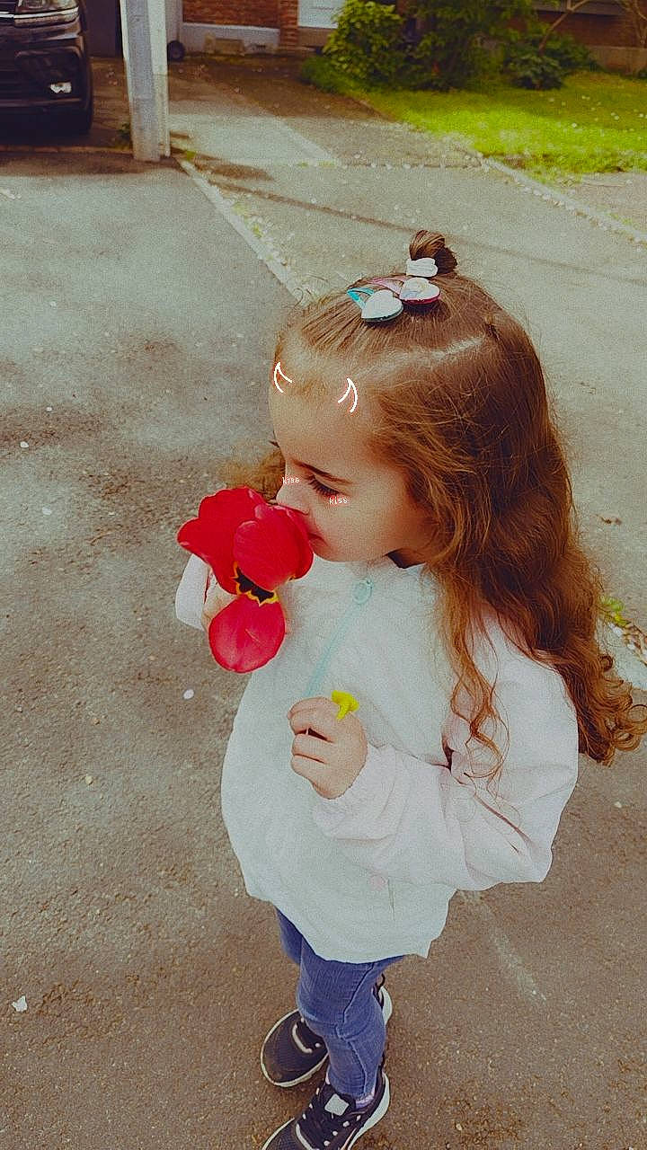 Amel a rejoint le concours — aidez-le/la à gagner de superbes lots ! baby_toddler_clothing, brown_hair, child, fashion_accessory, flower, fun, hair_accessory, hair_tie, happy, headpiece, long_hair, pattern, peach, person, petal, pink, plant, rose, skin, toddler