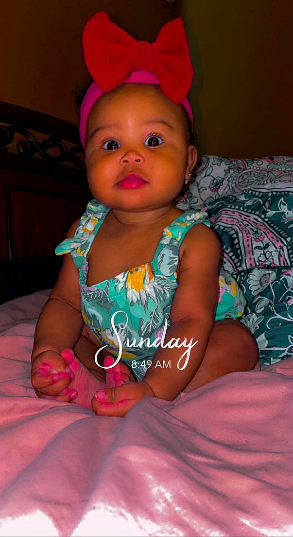 Averi is registered to the contest to win money with this photo: baby_toddler_clothing, cheek, chin, dress, eye, face, facial_expression, head, human, human_body, iris, leg, lip, mammal, mouth, organ, person, pink, purple, skin