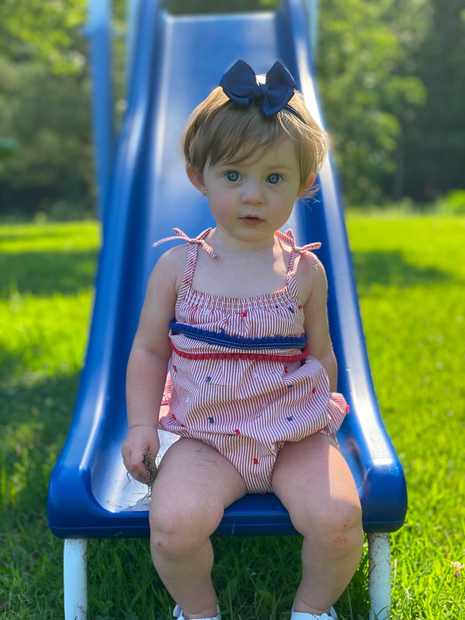 Maisie is registered to the contest to win money with this photo: azure, blue, dress, electric_blue, fun, grass, green, hair, hairstyle, happy, leisure, long_hair, people_in_nature, person, plant, shoulder, skin, summer, surprise, toddler