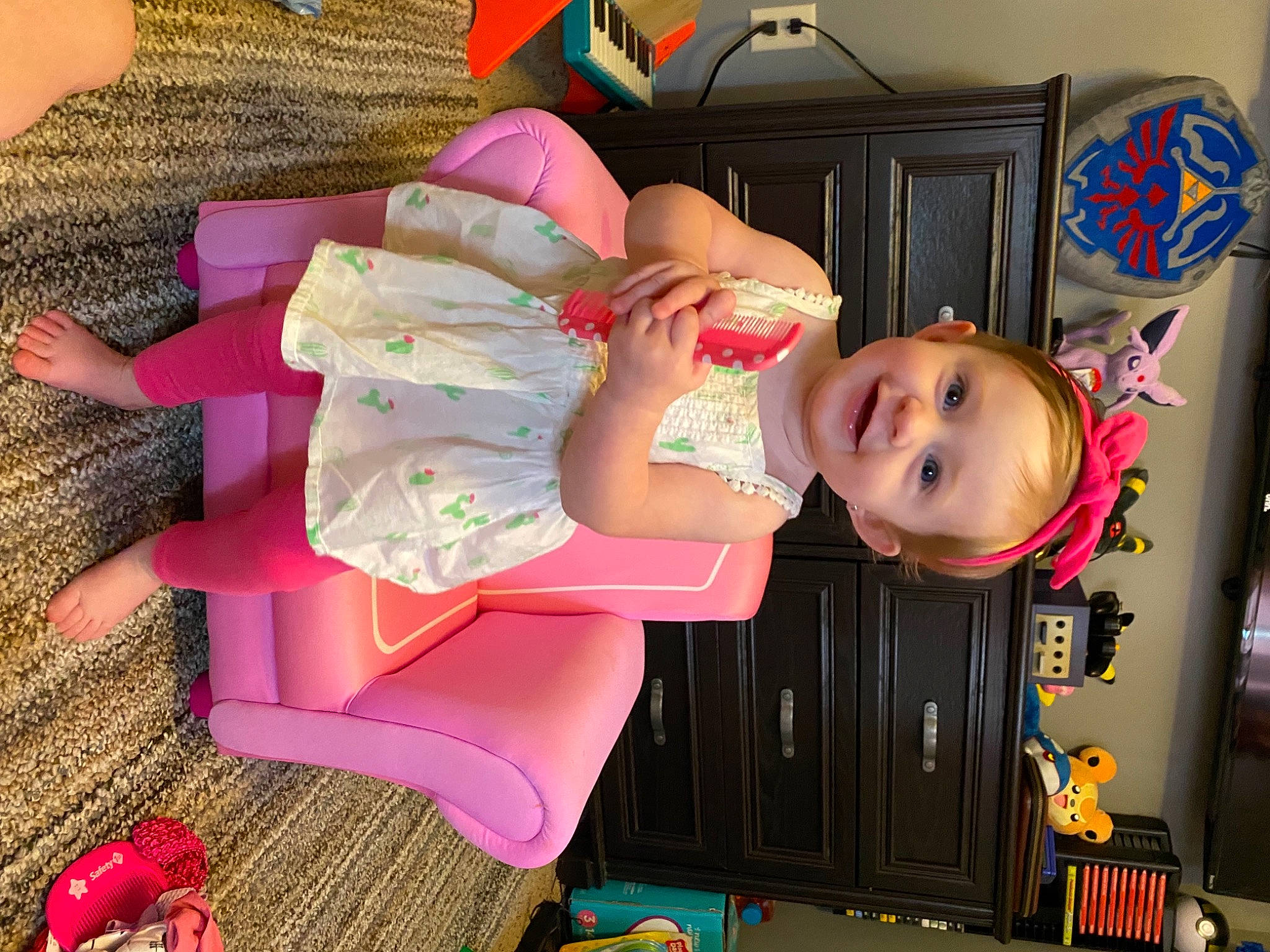 Maisie is registered to the contest to win money with this photo: baby, baby_products, baby_toddler_clothing, child, facial_expression, flooring, fun, happy, hat, joy, magenta, pattern, person, pink, room, smile, textile, toddler, vacation, wood