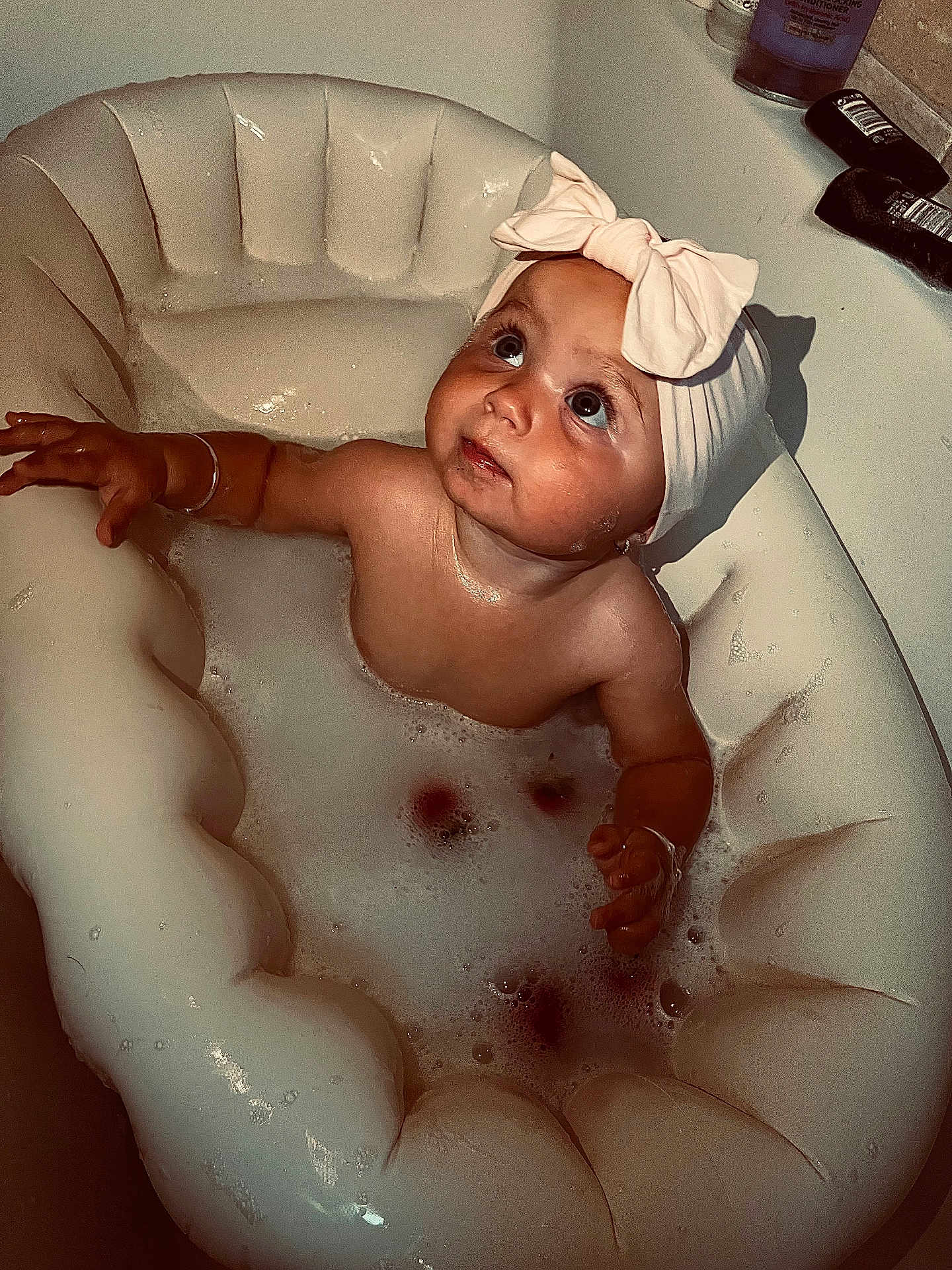 Renee joined the competition — help win amazing prizes! baby, child, bath, bathtub, bubbles, inflatable_tub, headband, bow, water, skin, arm, face, looking_up, foam, indoor, cute, adorable, childhood, happy, playful