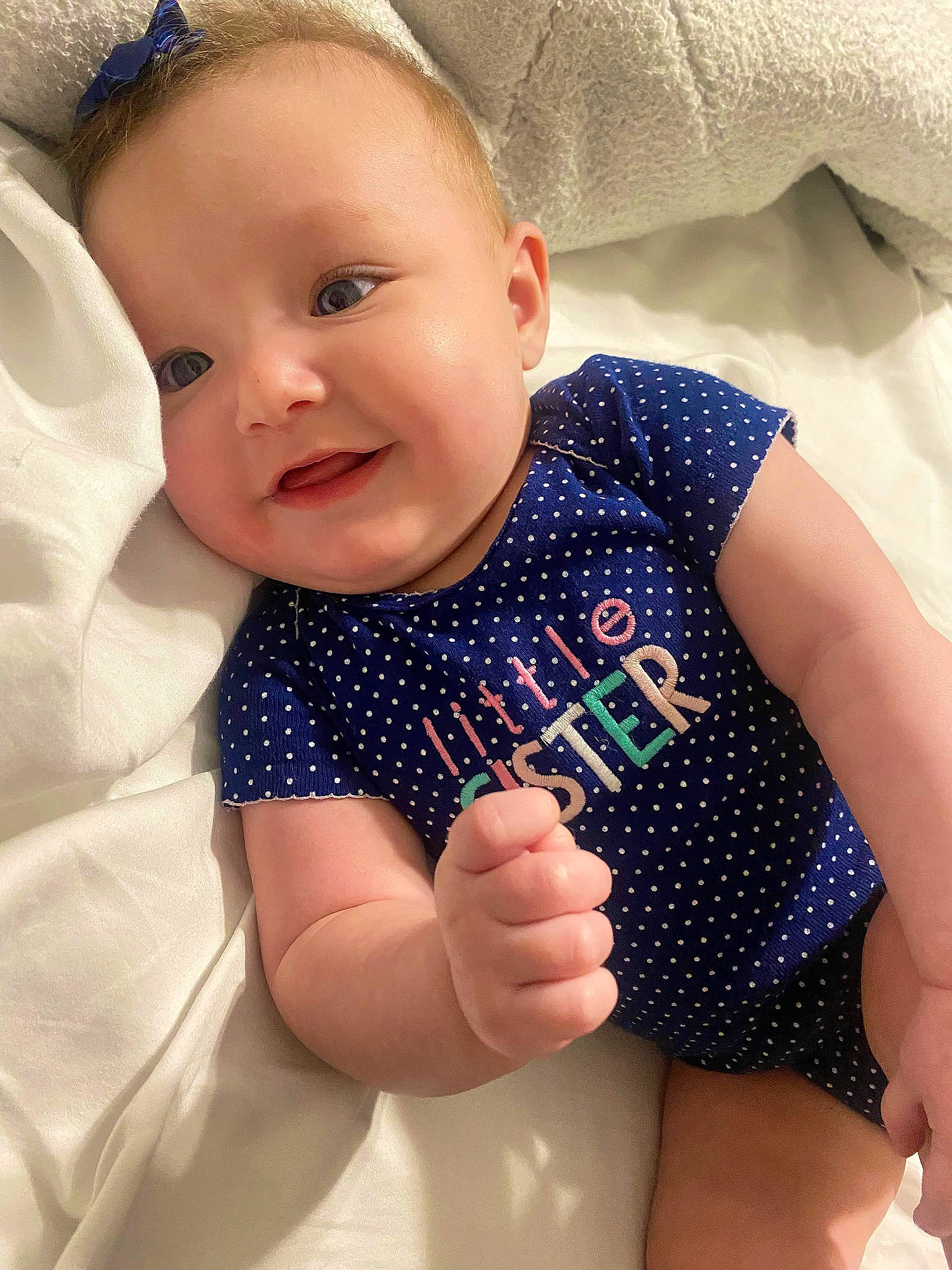 Charleigh is registered to the contest to win money with this photo: arm, baby, baby_toddler_clothing, child, eye, face, finger, gesture, hairstyle, hand, happy, head, iris, lip, person, skin, sleeve, smile, thigh, thumb
