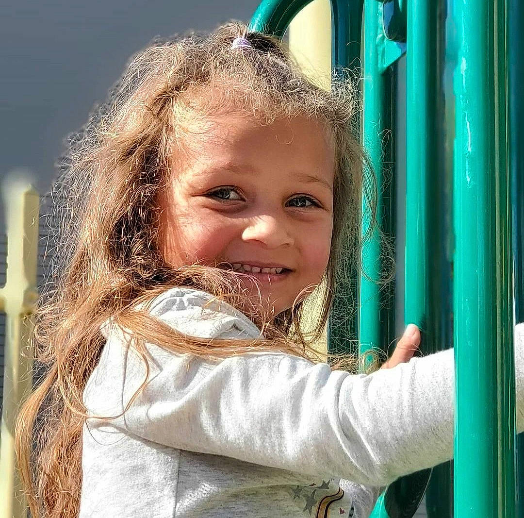 Jaycee is registered to the contest to win money with this photo: blond, child, chin, chute, facial_expression, fun, grass, hair, happy, human, iris, joy, leisure, lip, nose, people_in_nature, person, play, recreation, smile